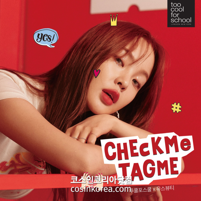 투쿨포스쿨 모델이 'CHECKME TAGME' 문구가 적힌 제품을 들고 포즈를 취하고 있다.