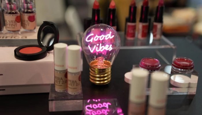 진열된 화장품과 'Good Vibes'라고 쓰인 네온 조명.